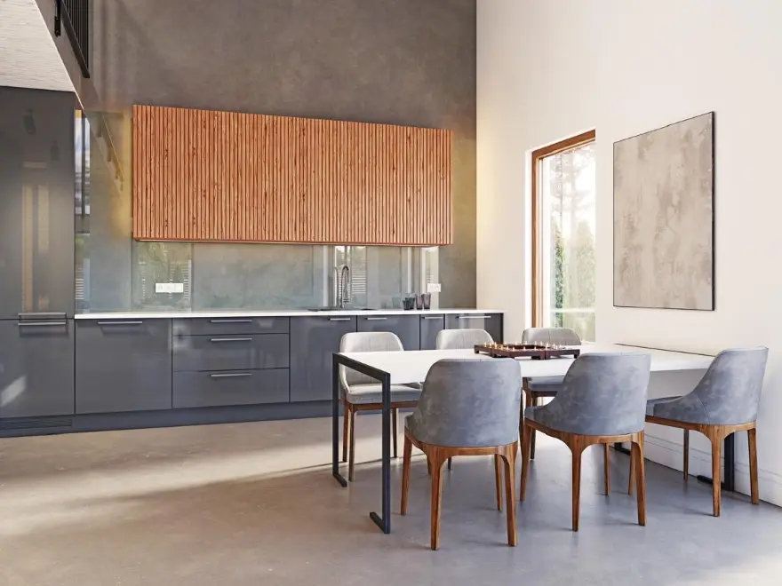 Cocina comedor con suelo y pared de microcemento gris, muebles grises y mueble alto de madera en Elche